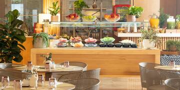 a buffet with a glass shelf and a variety of food on it