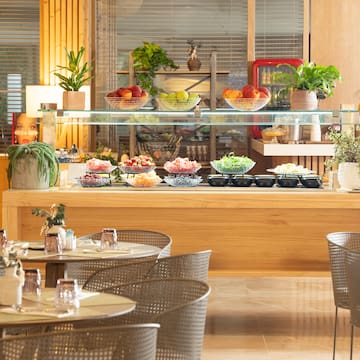 a buffet with a glass shelf and a variety of food on it