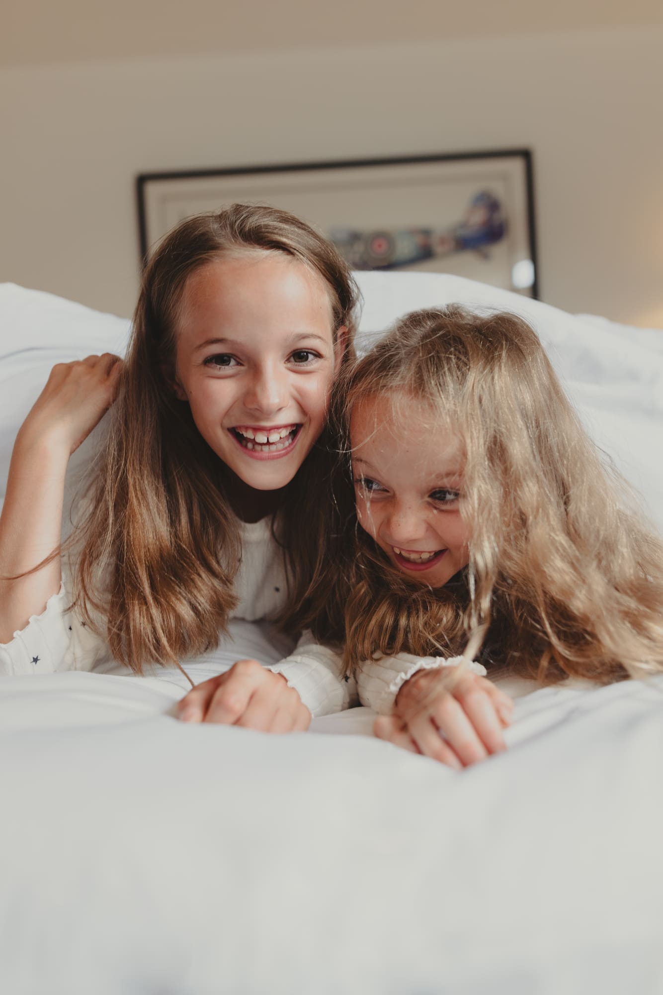 two girls lying on a bed