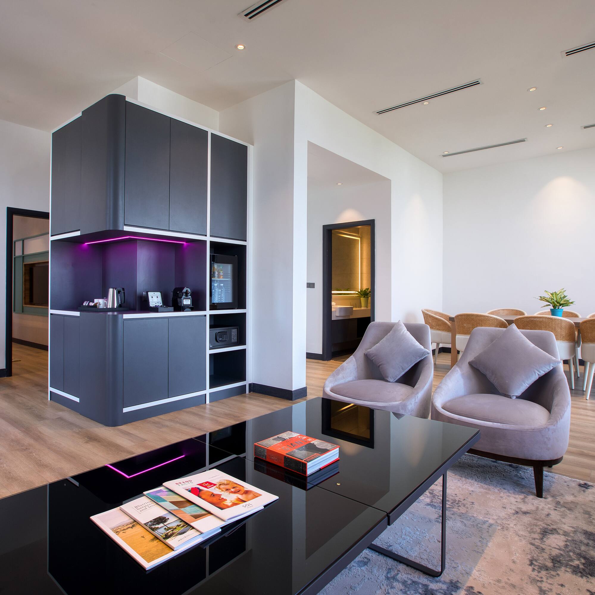 a room with a black table and chairs