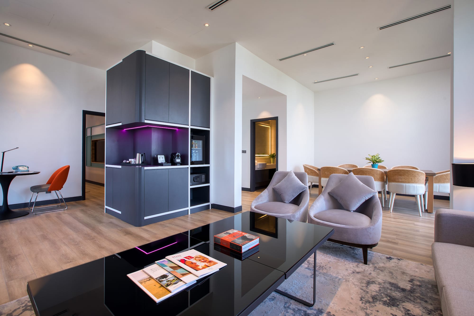 a room with a black table and chairs