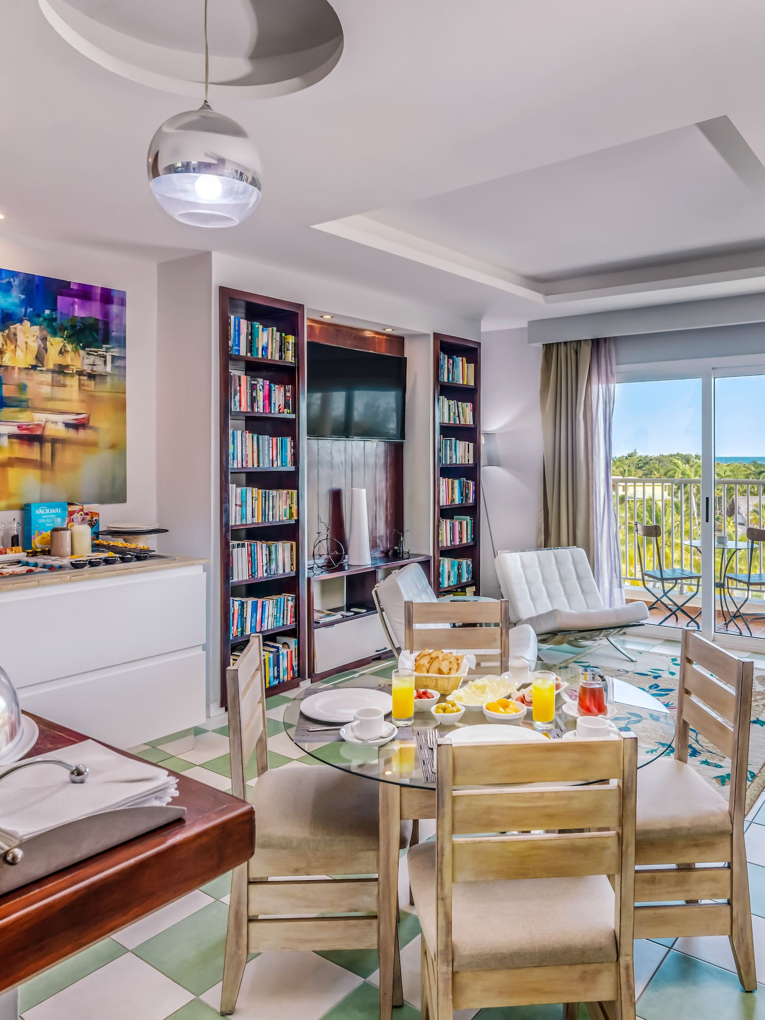 a room with a table and chairs and a television