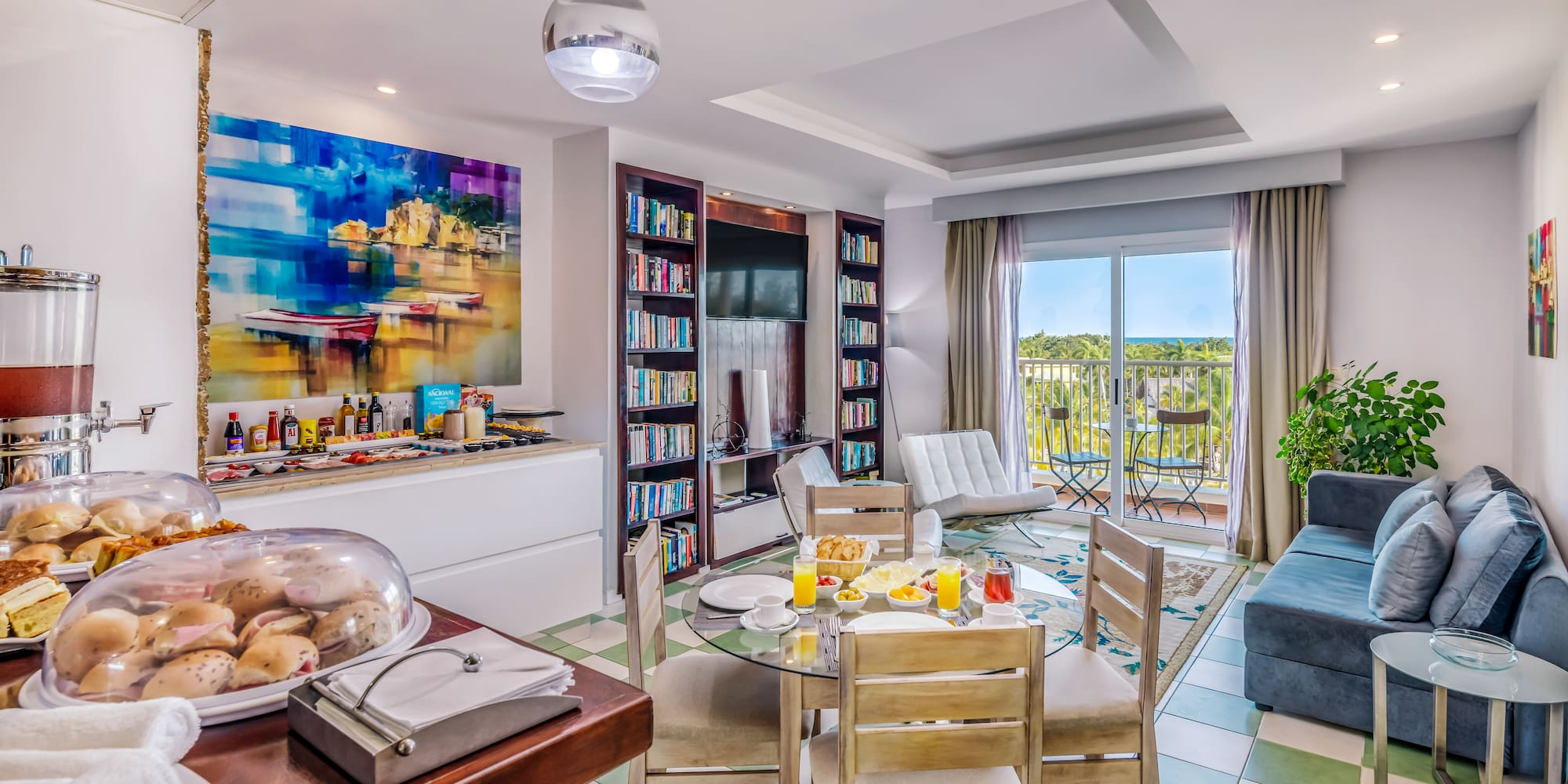 a room with a table and chairs and a television