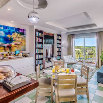 a room with a table and chairs and a television