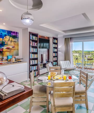 a room with a table and chairs and a television