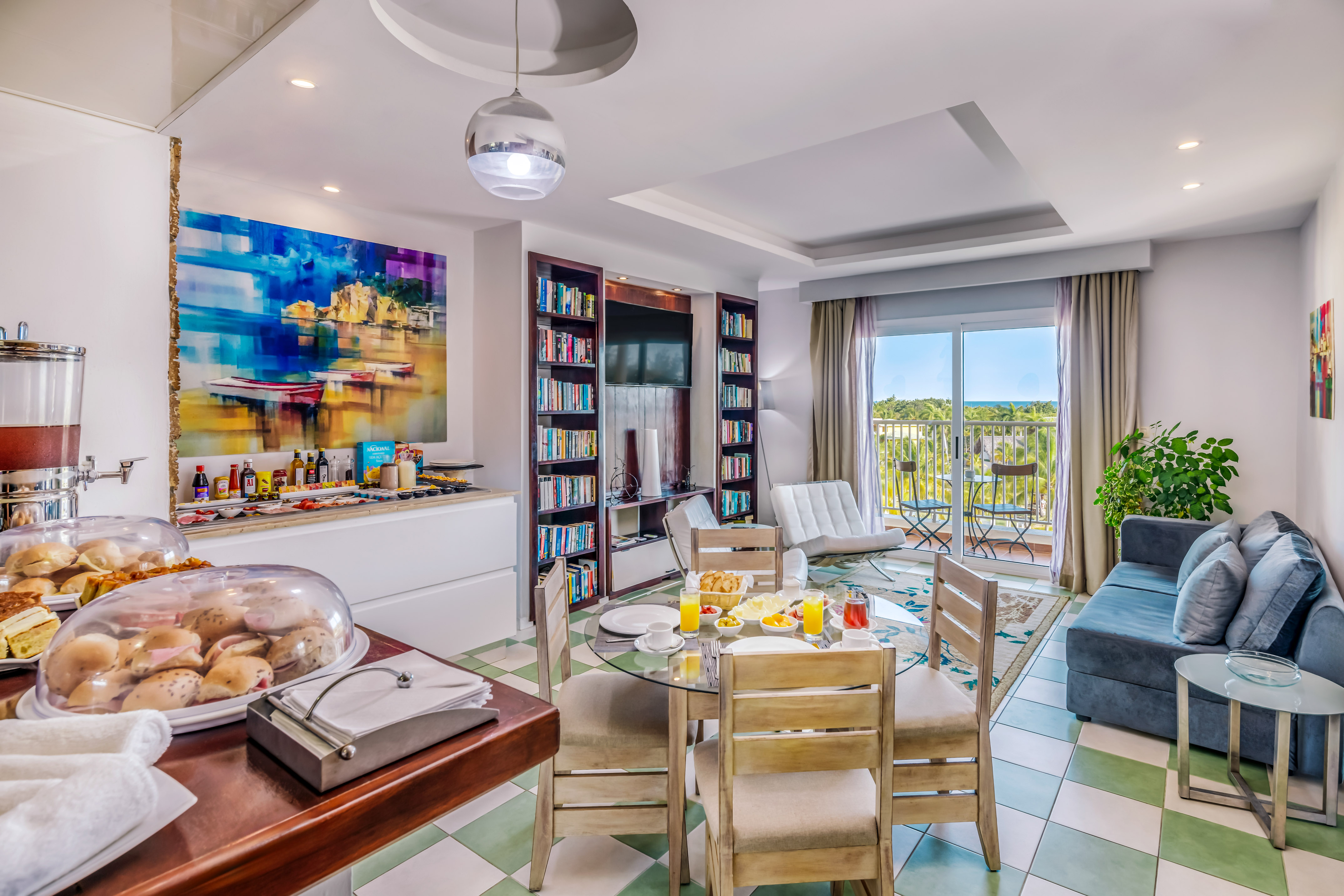 a room with a table and chairs and a television