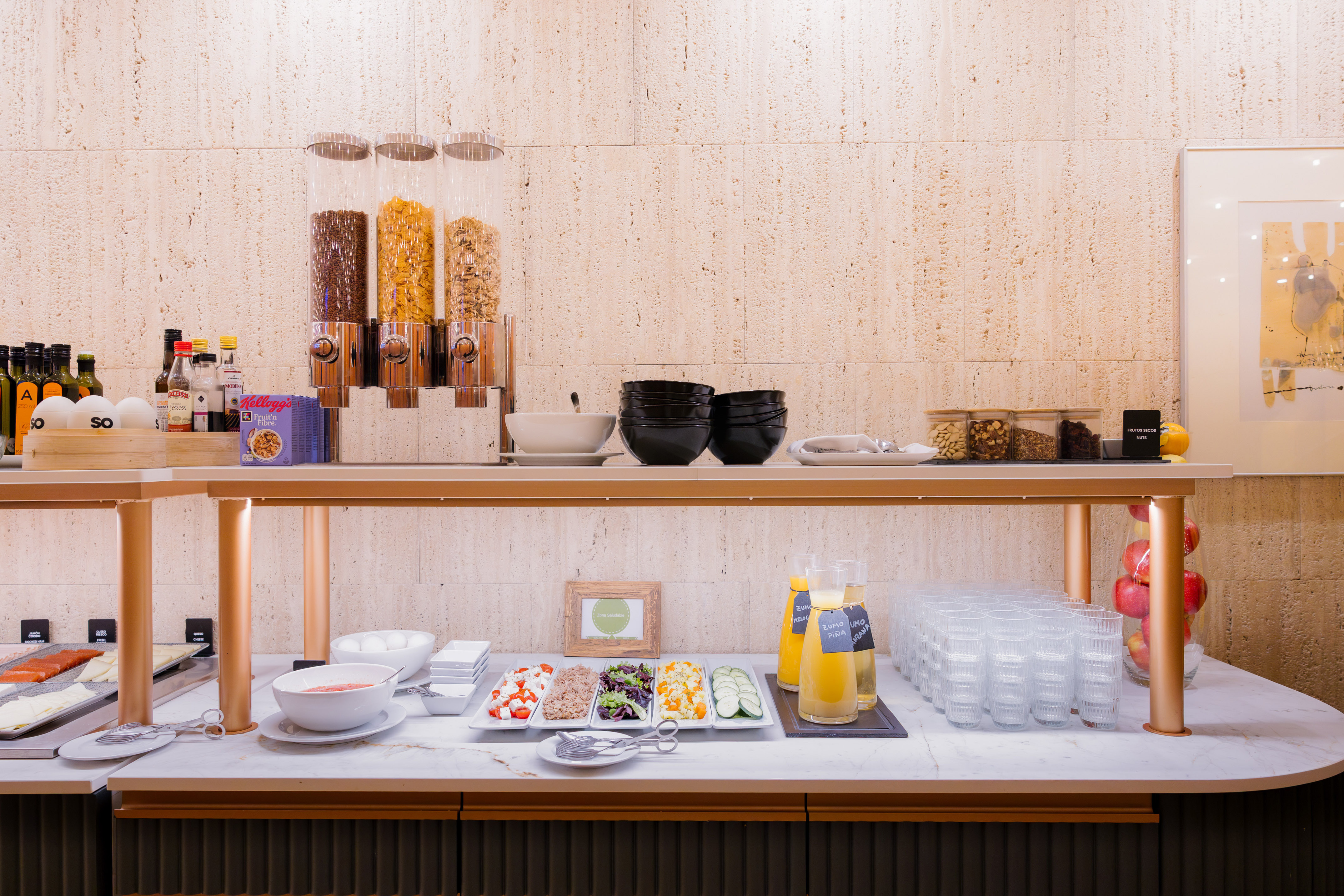 Breakfast buffet featuring cereals, juices, fresh fruit, salmon, and healthy options.
