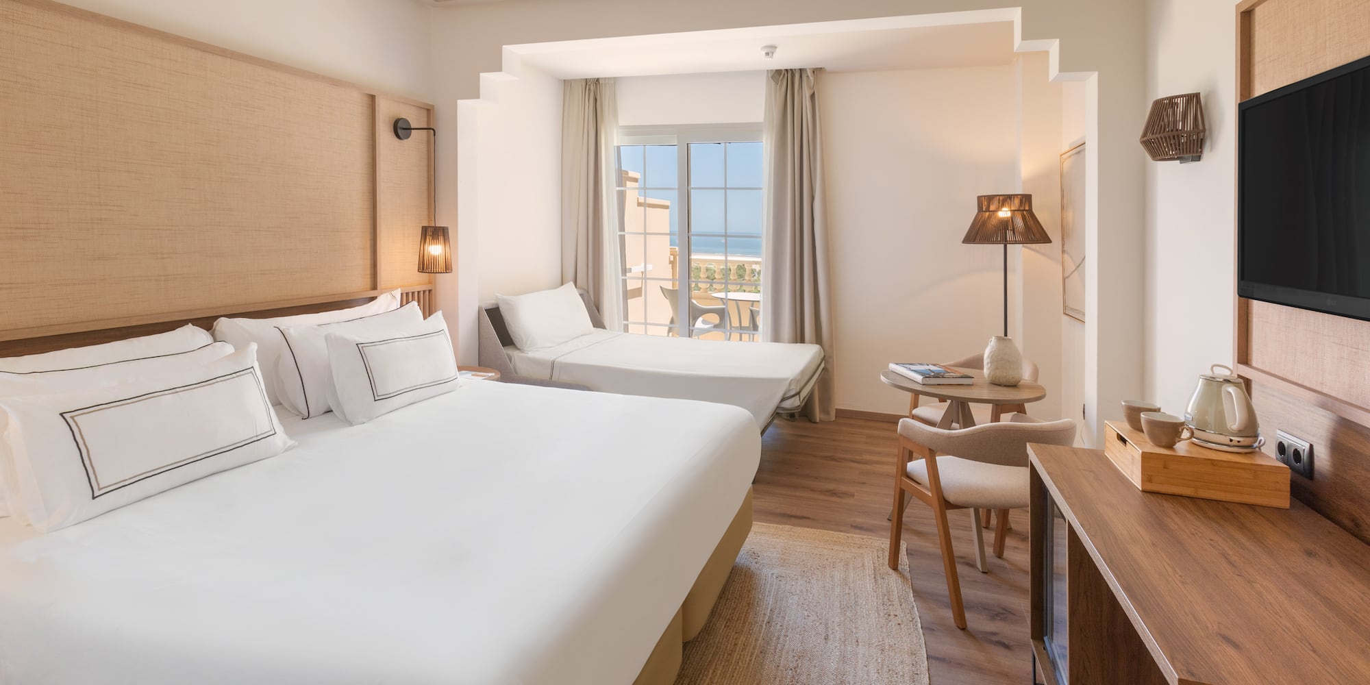 a room with two beds and a table