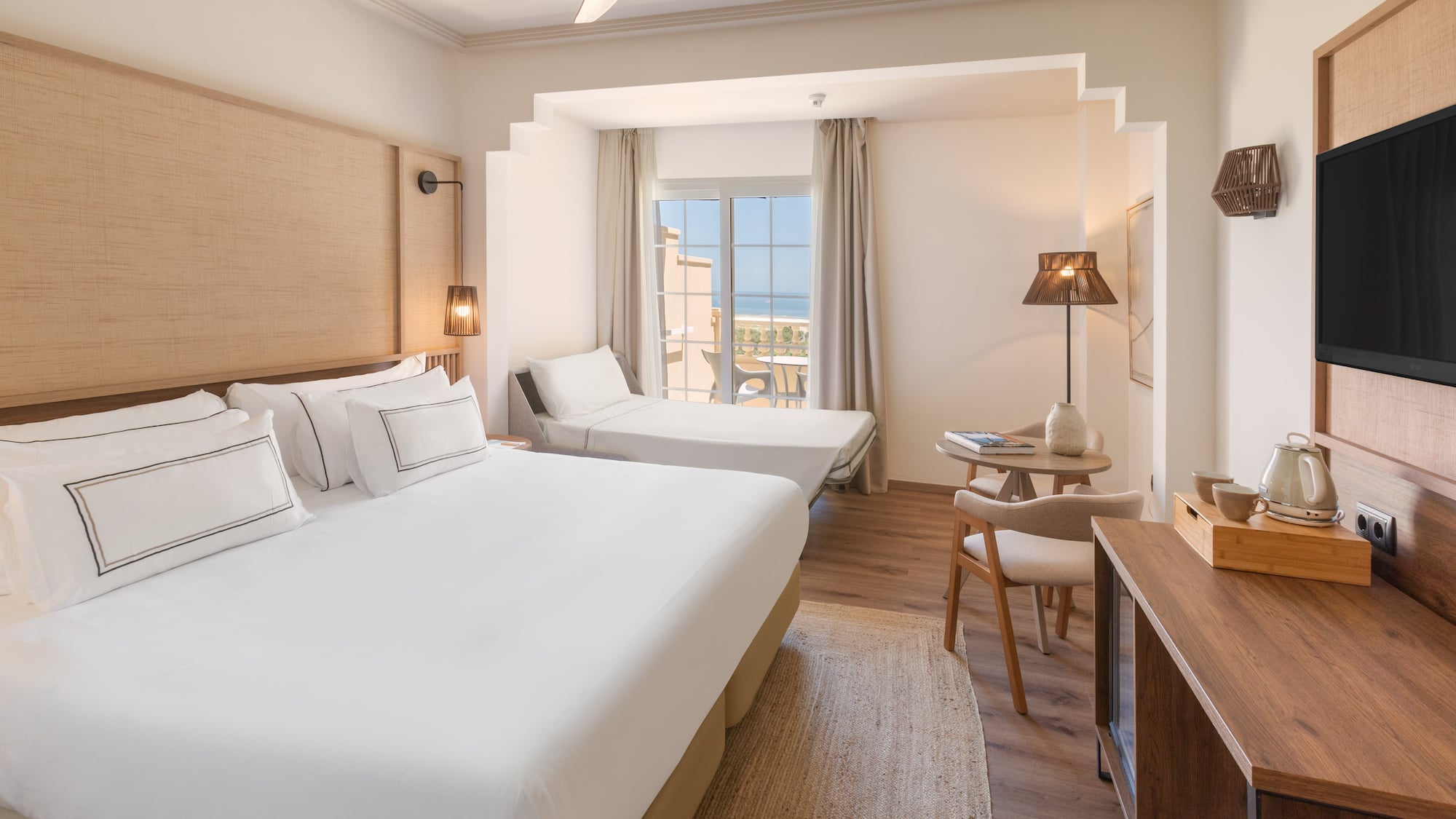 a room with two beds and a table