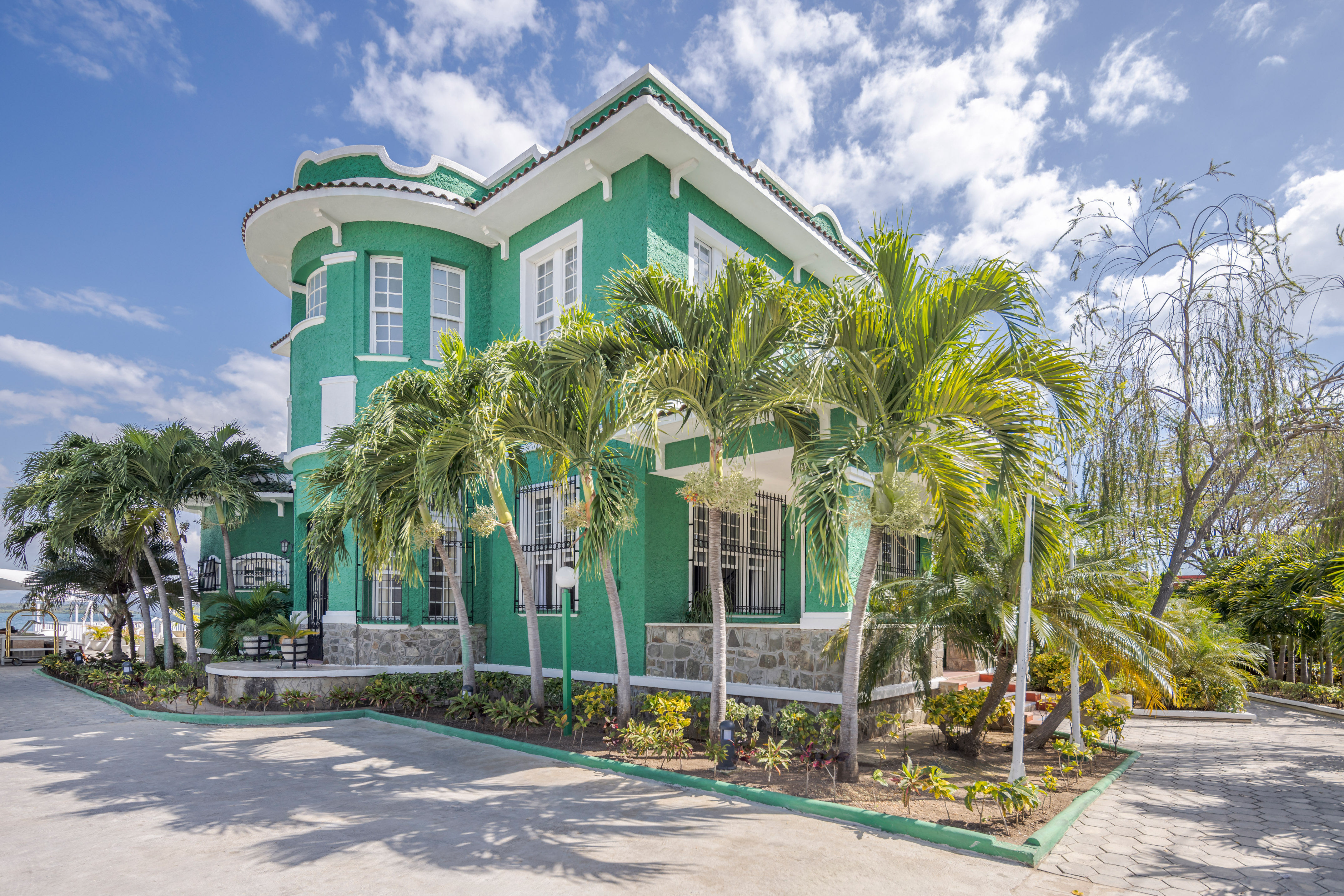 a green house with palm trees