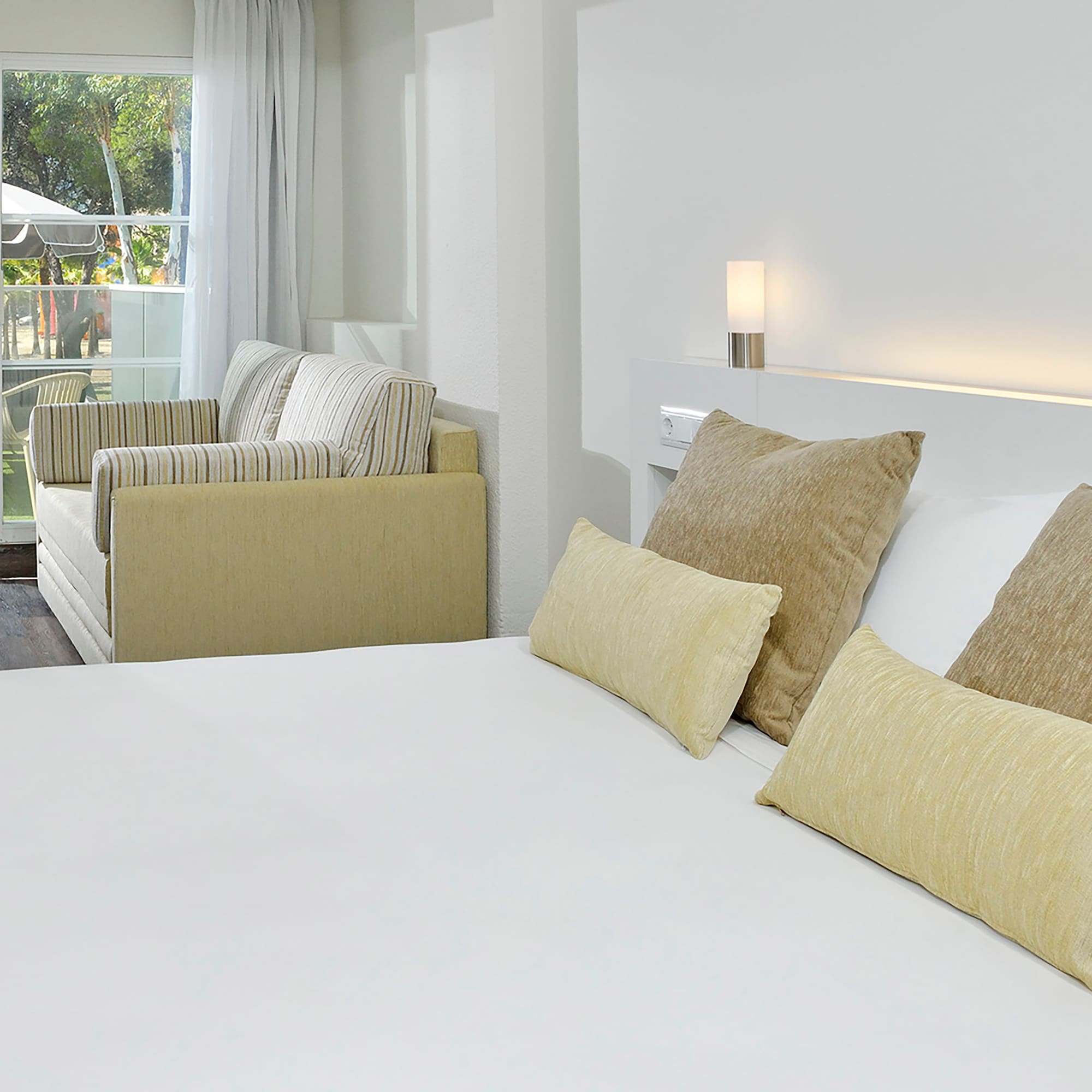 a bed with pillows in a room