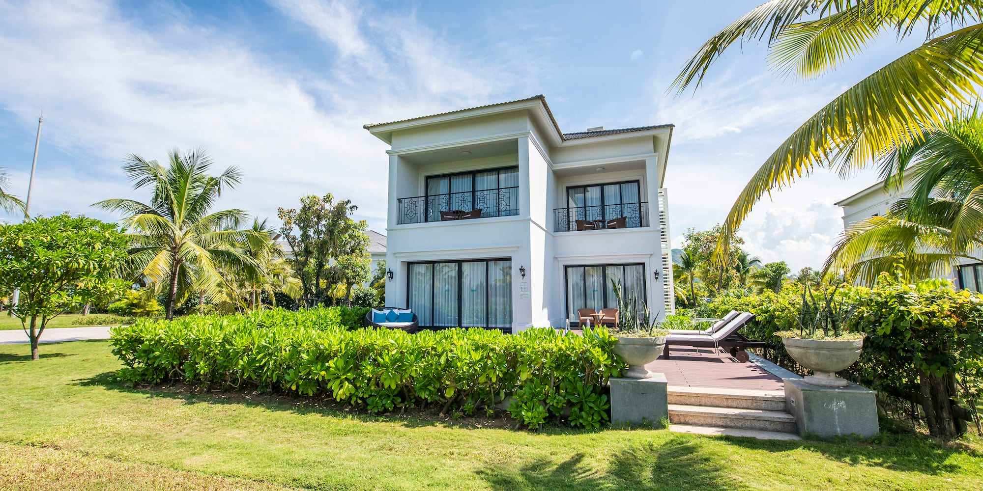 a house with a lawn and palm trees