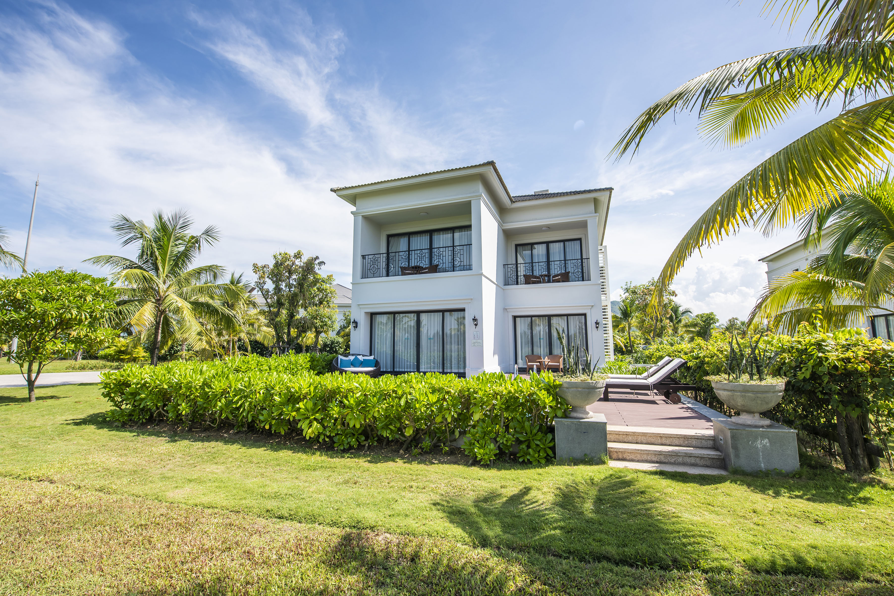 a house with a lawn and palm trees