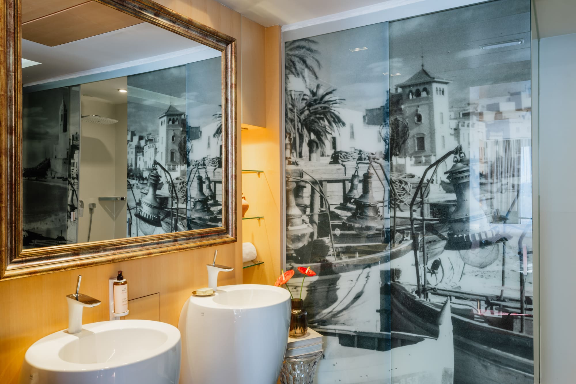 a bathroom with a mirror and a picture of a boat