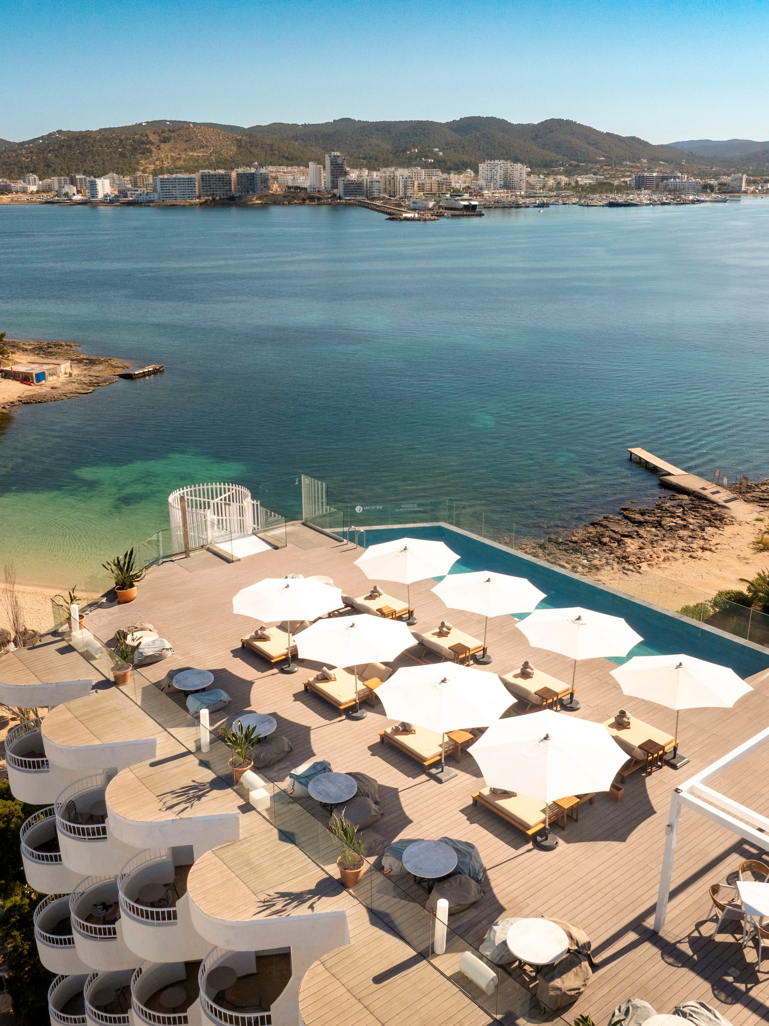 a beach with umbrellas and chairs and a body of water