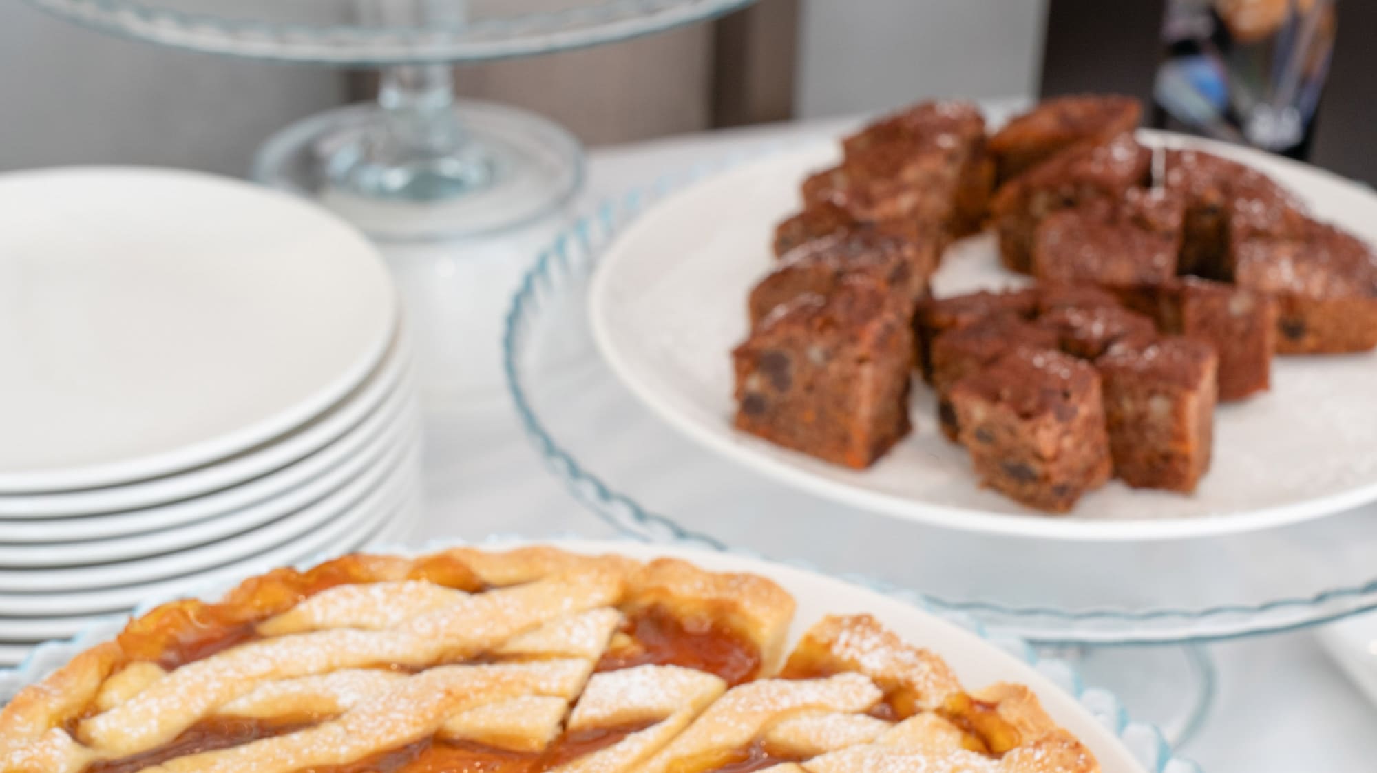 a table with plates of pies and plates of food