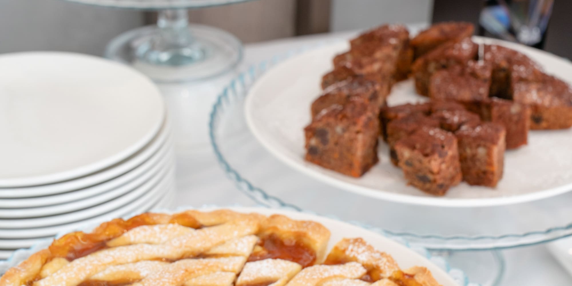 a table with plates of pies and plates of food