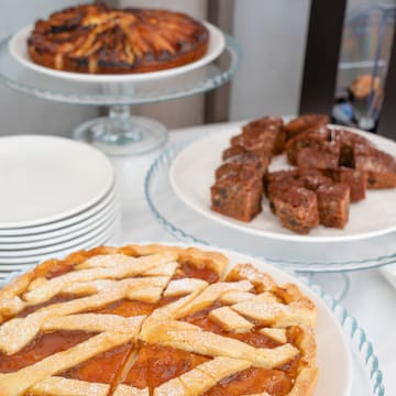 a table with plates of pies and plates of food