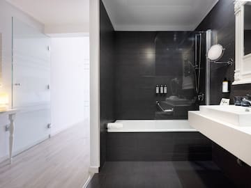 a bathroom with a tub and shower