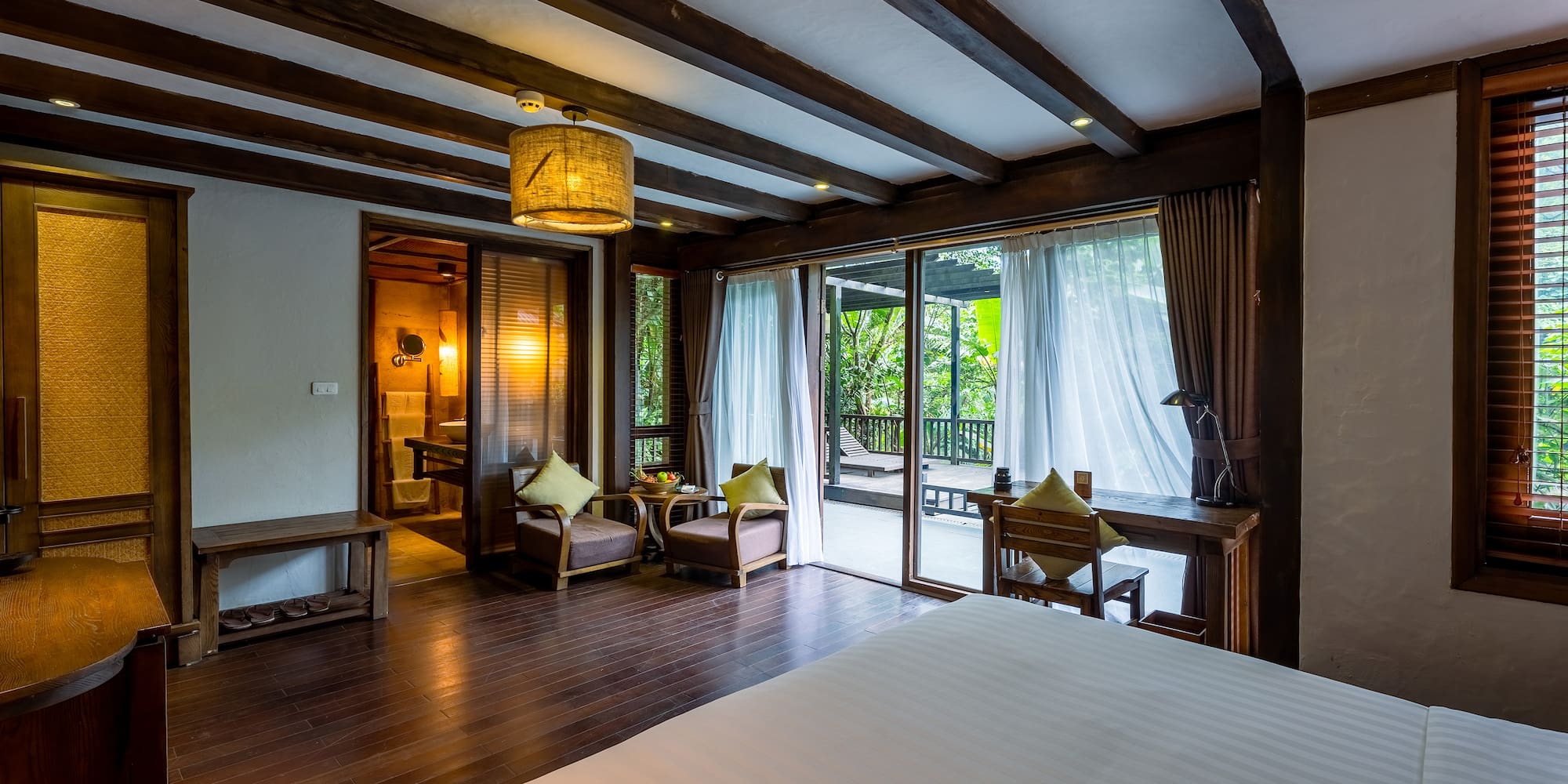 a room with a bed and chairs