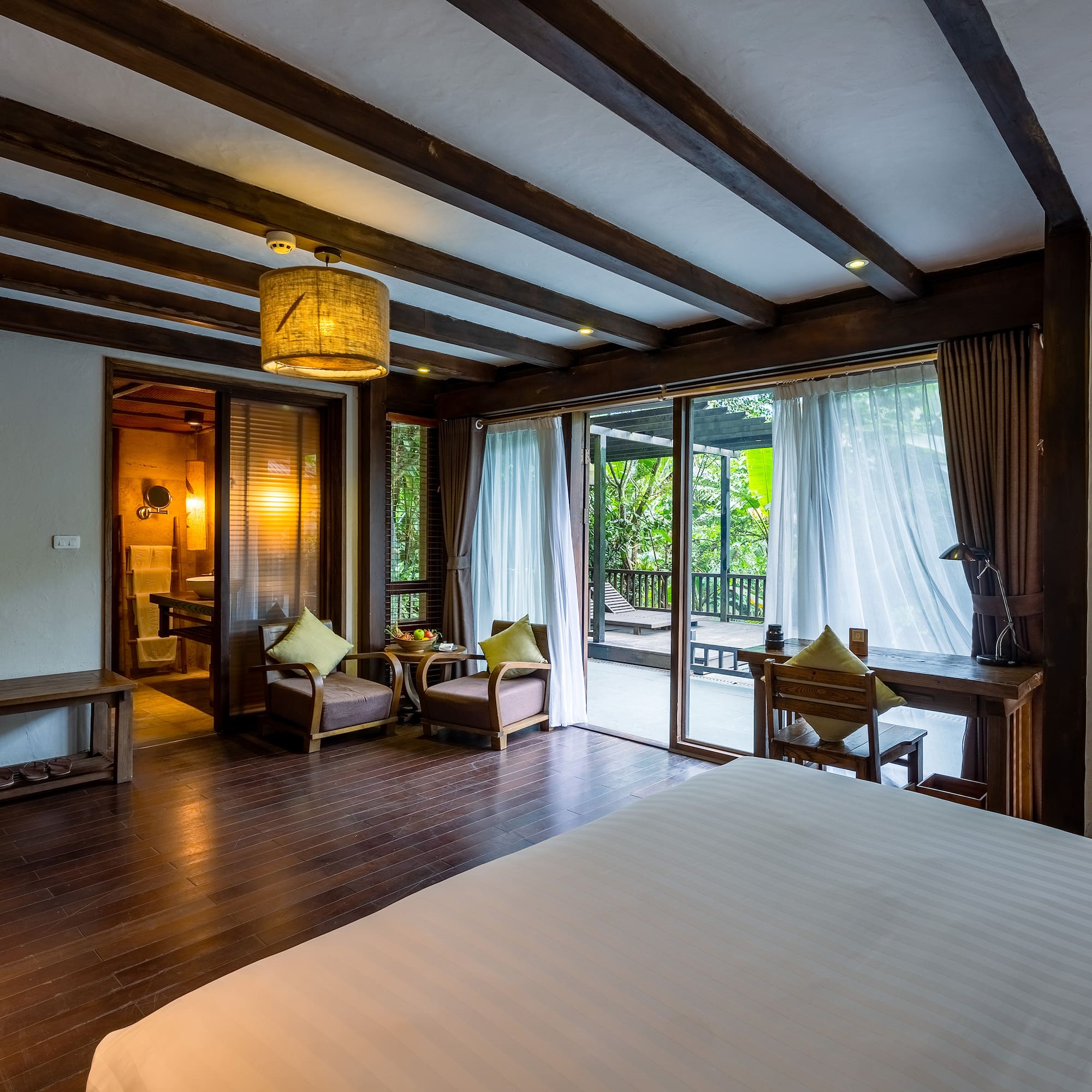 a room with a bed and chairs