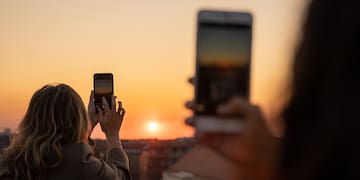 a group of people taking a picture of the sunset