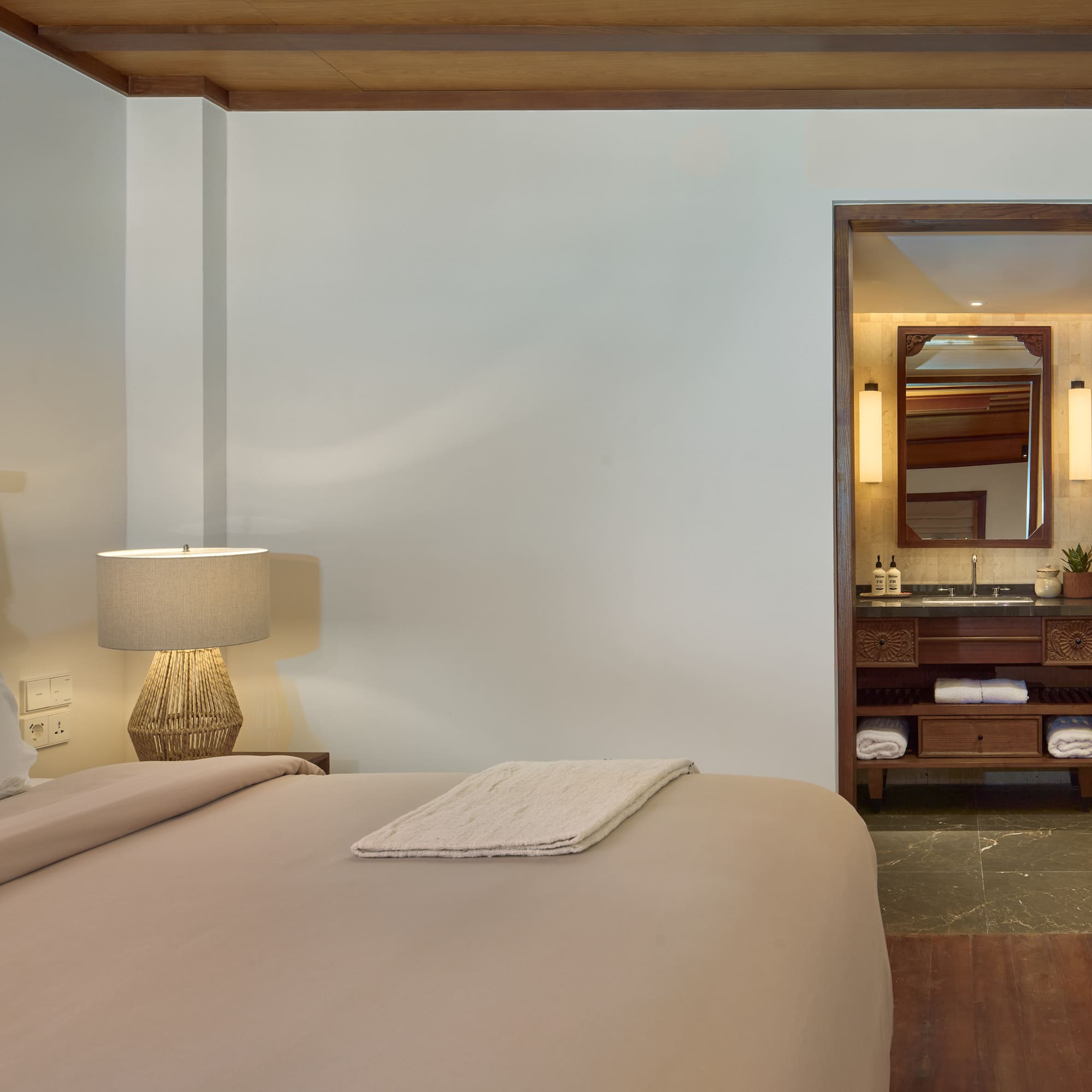 a bedroom with a bed and a mirror