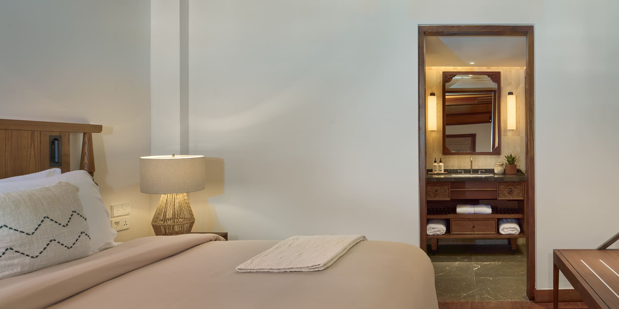 a bedroom with a bed and a mirror