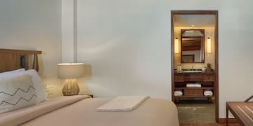 a bedroom with a bed and a mirror