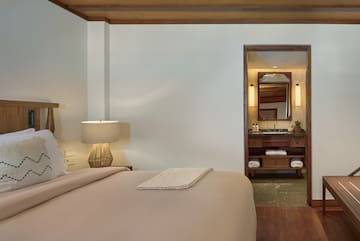 a bedroom with a bed and a mirror