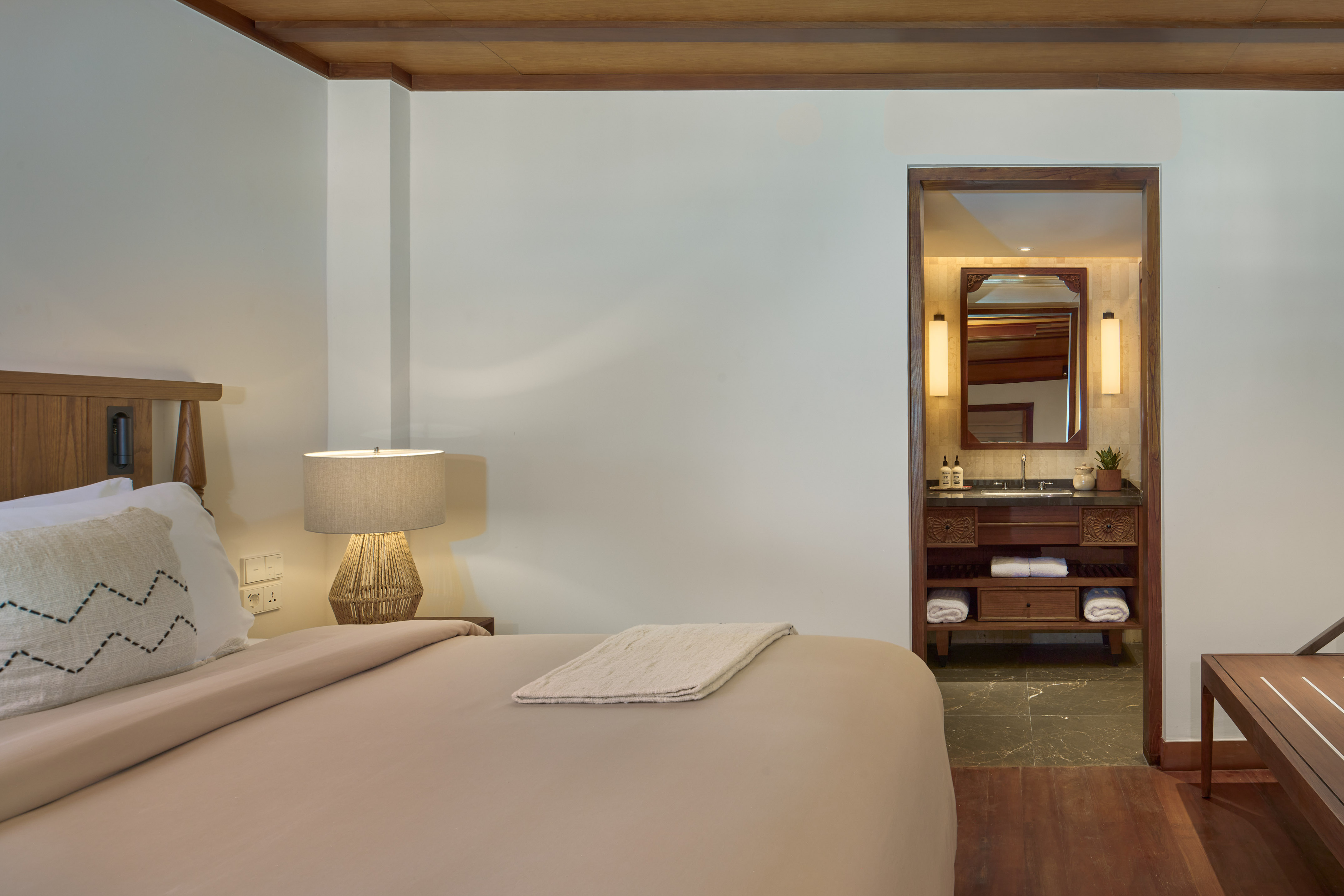 a bedroom with a bed and a mirror