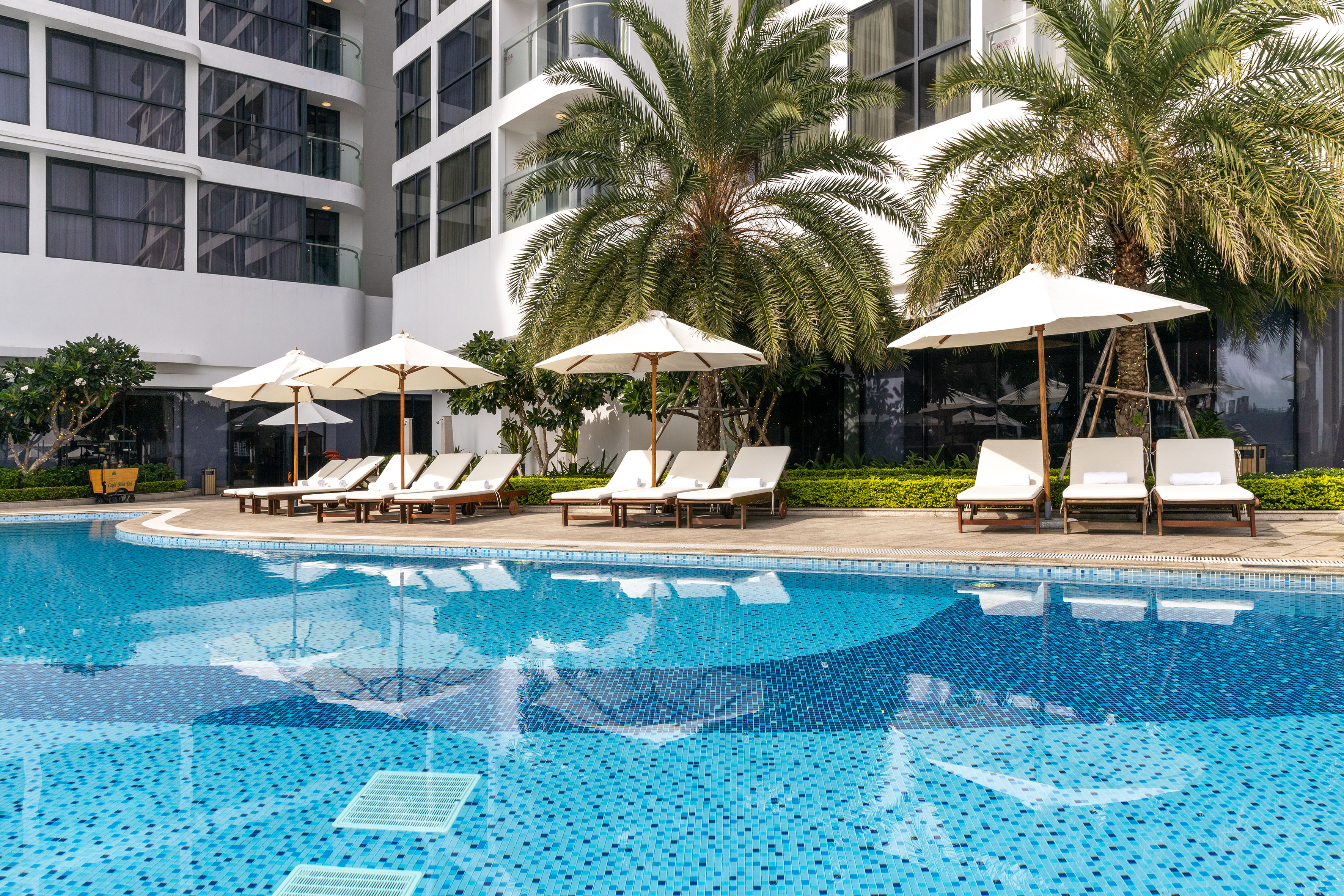 a pool with umbrellas and lounge chairs