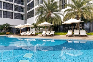 a pool with umbrellas and lounge chairs