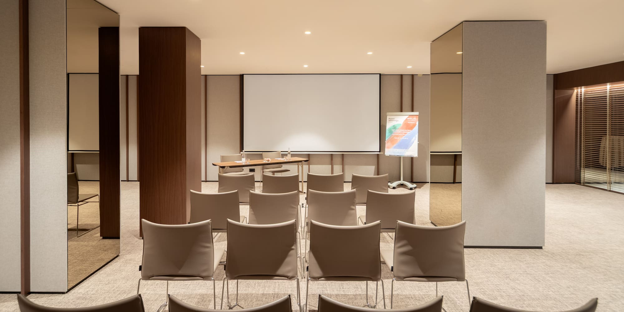 a room with chairs and a projector screen