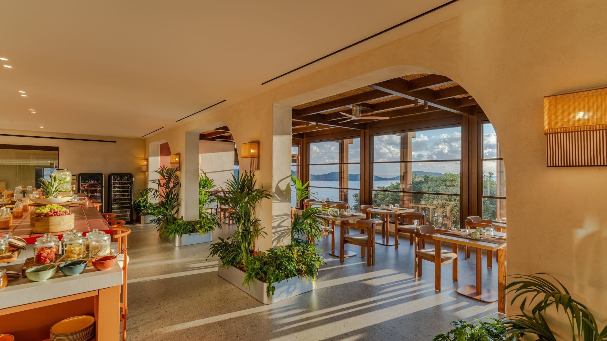 a room with tables and chairs and plants
