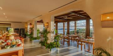 a room with tables and chairs and plants