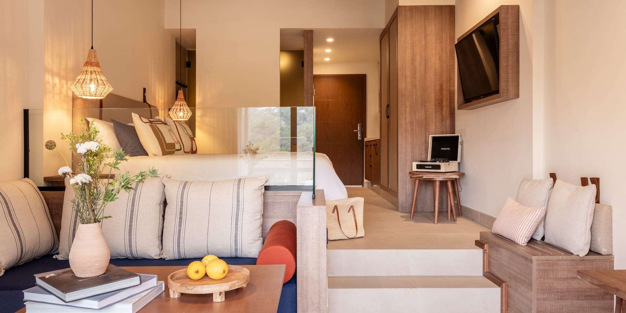 a room with stairs and couch and a tv