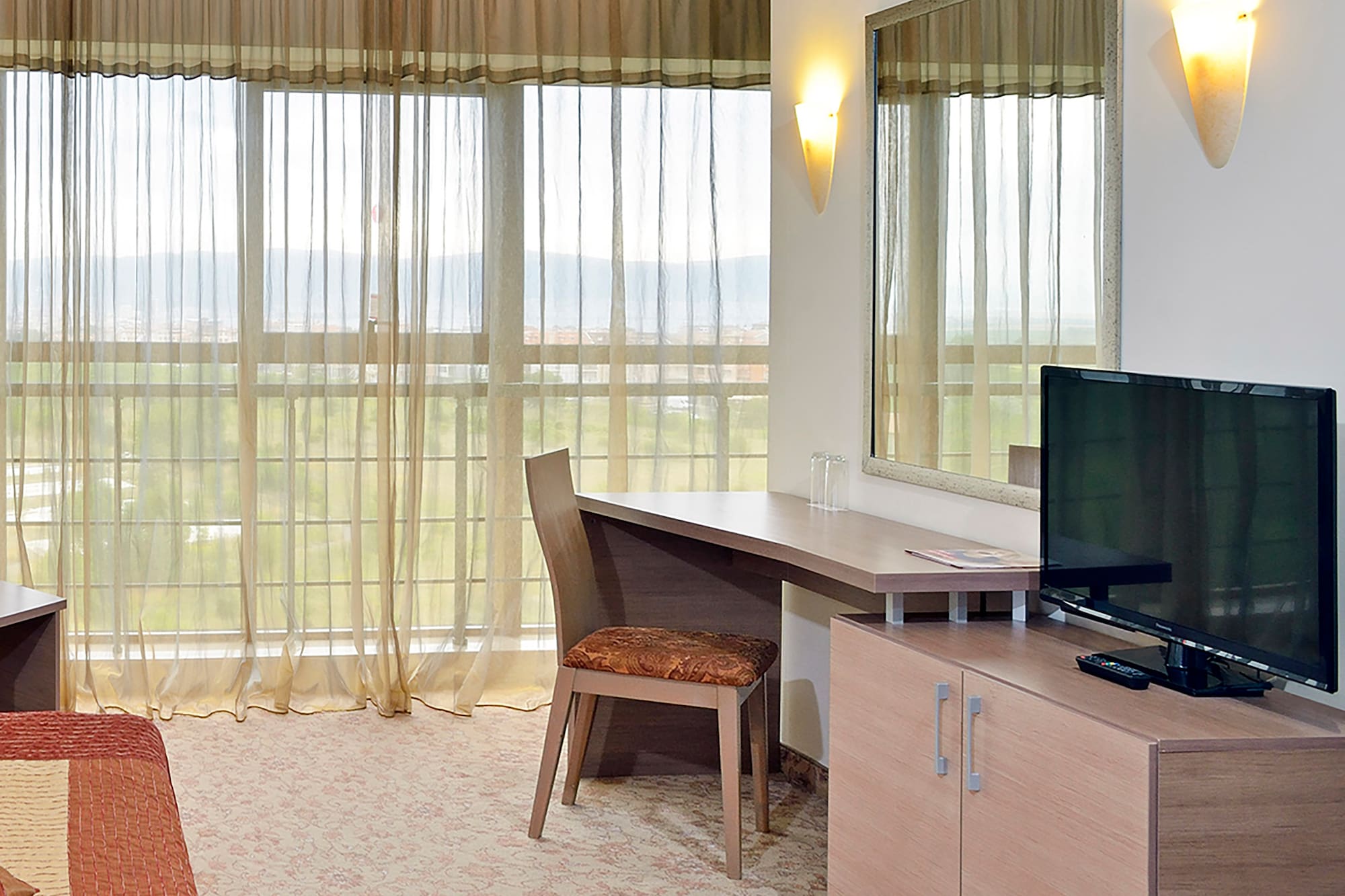 a room with a bed and a television