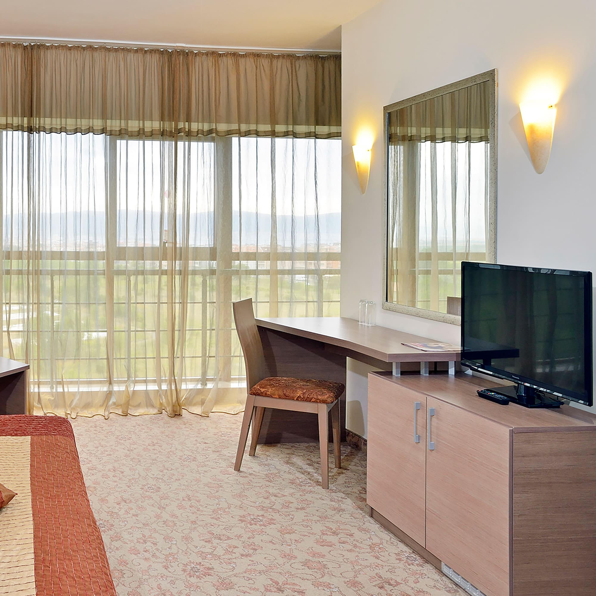 a room with a bed and a television