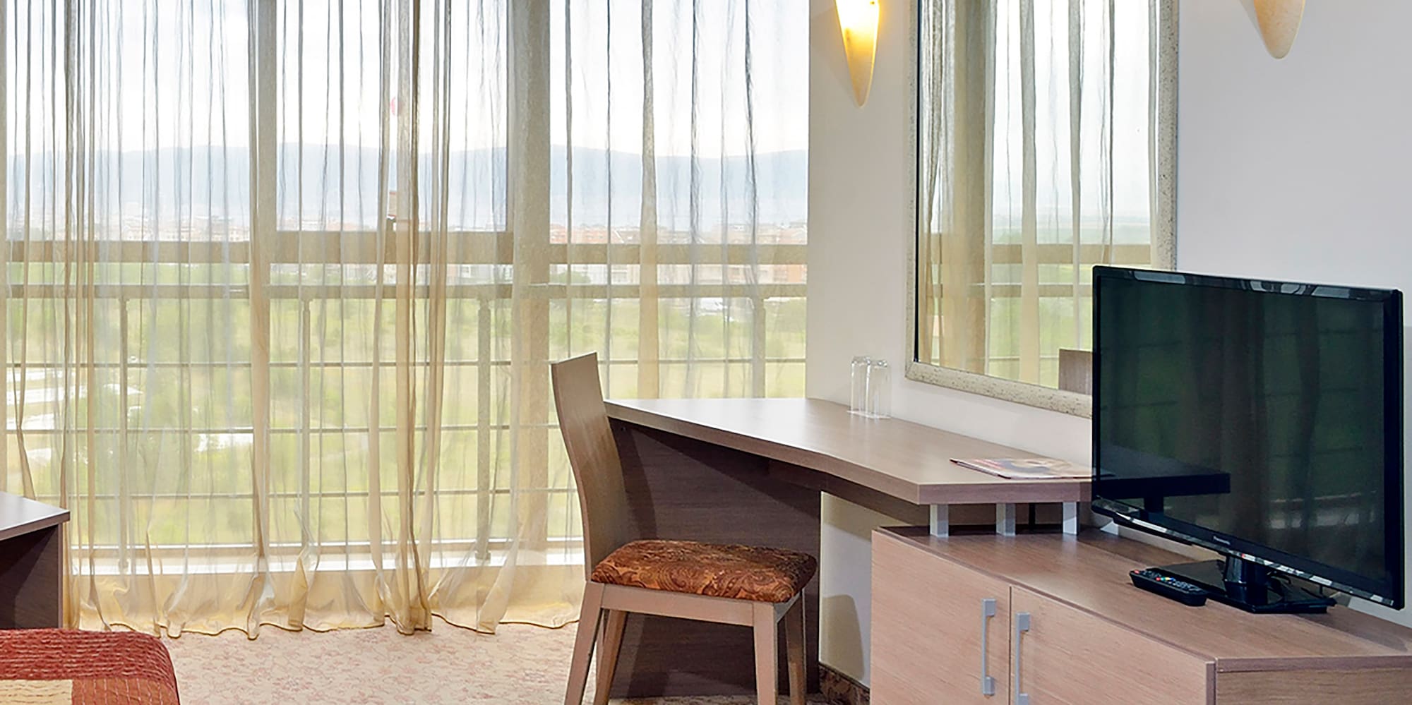 a room with a bed and a television