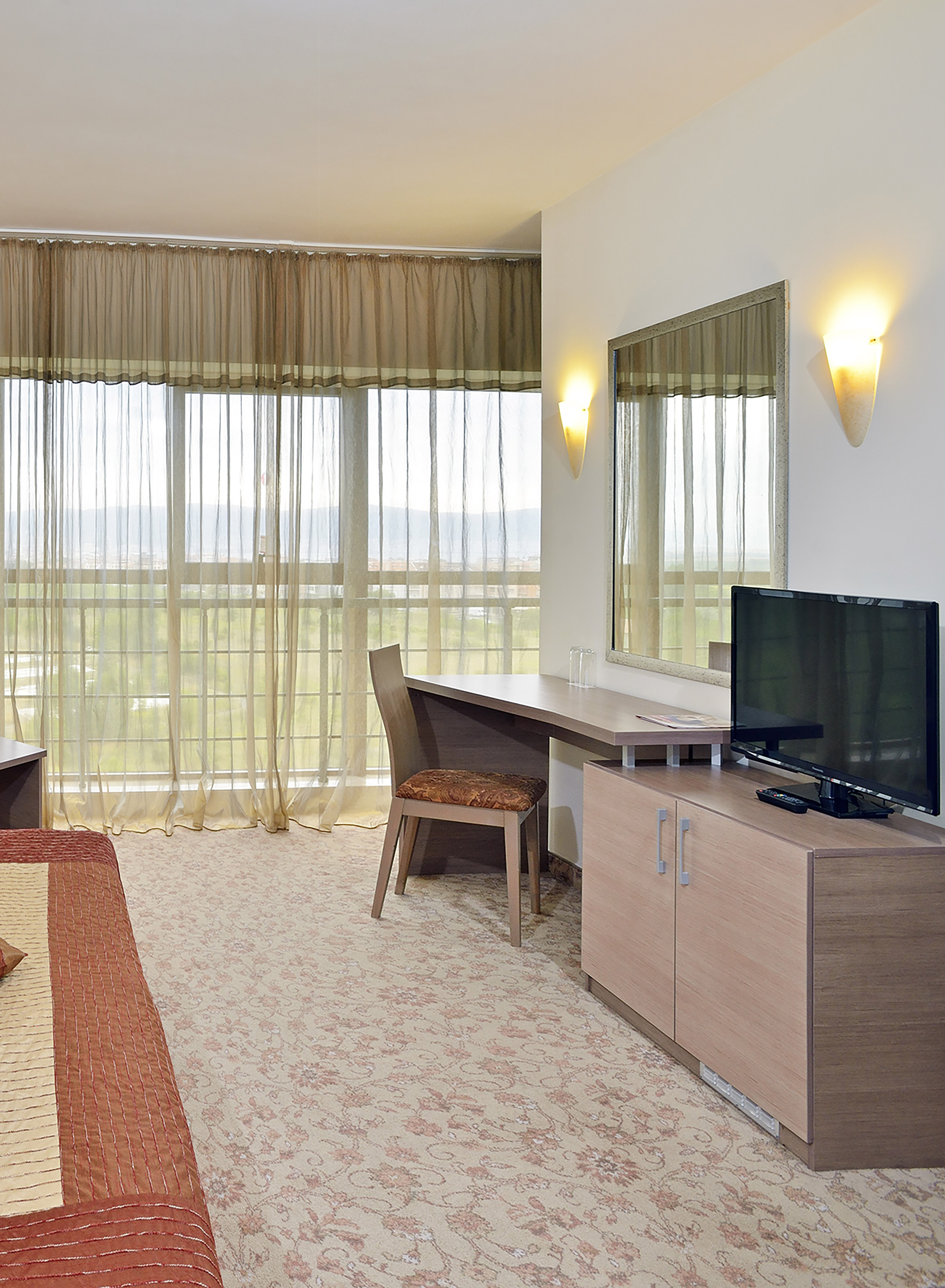 a room with a bed and a television