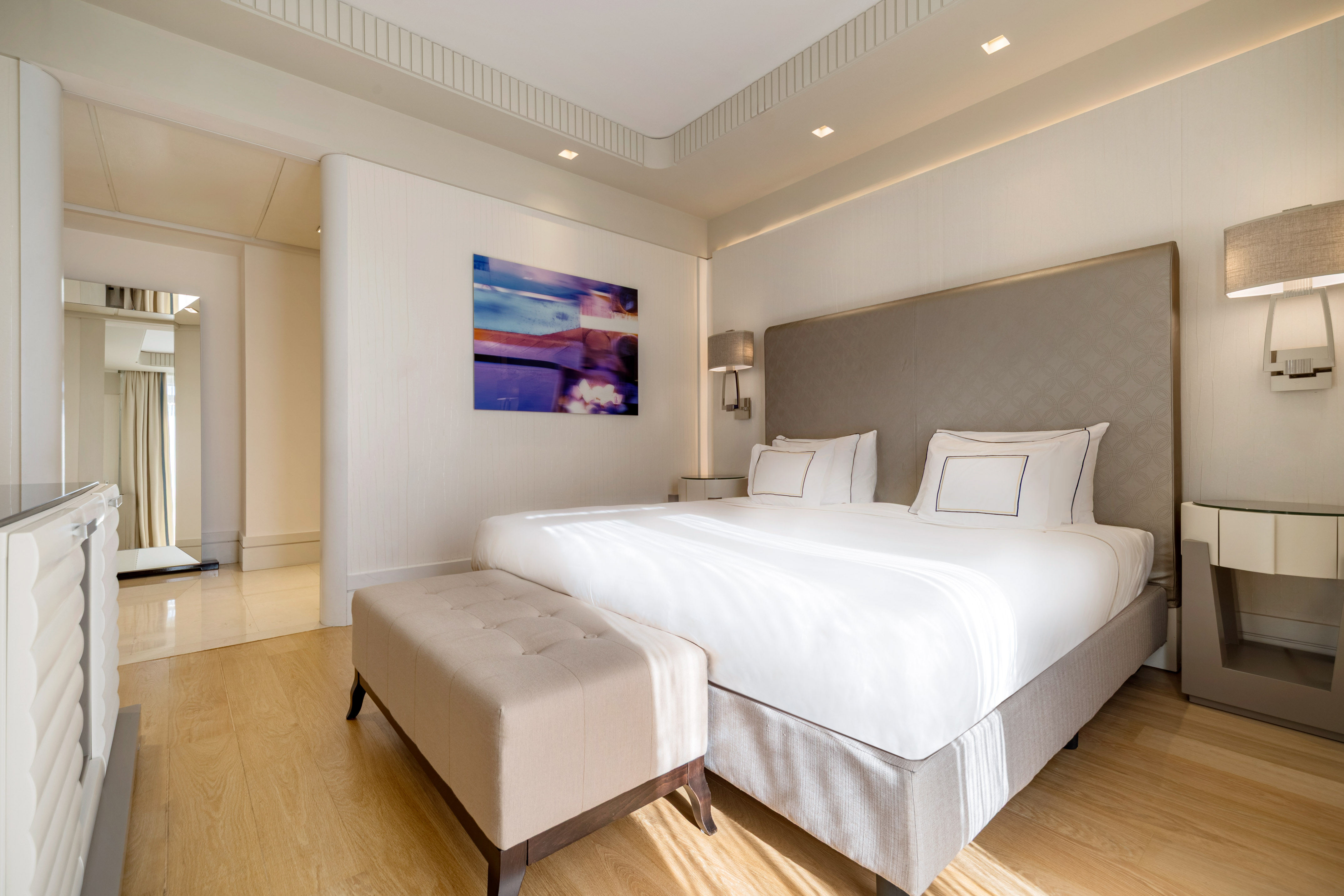 Modern luxury hotel bedroom with king bed, abstract art, and light wood floor. - Presidential Suite met Terras - Meliá Genova, Genua