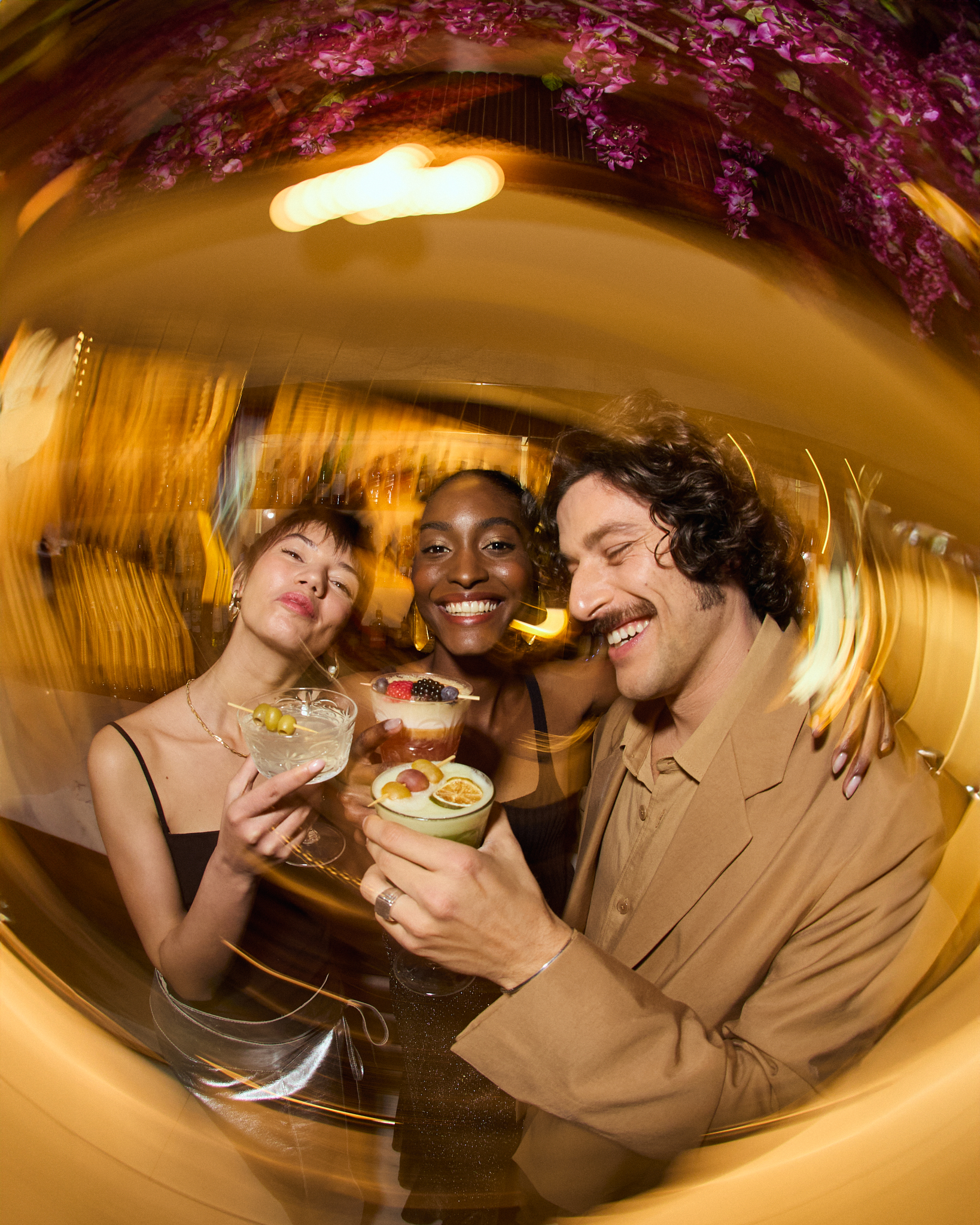 a group of people holding drinks