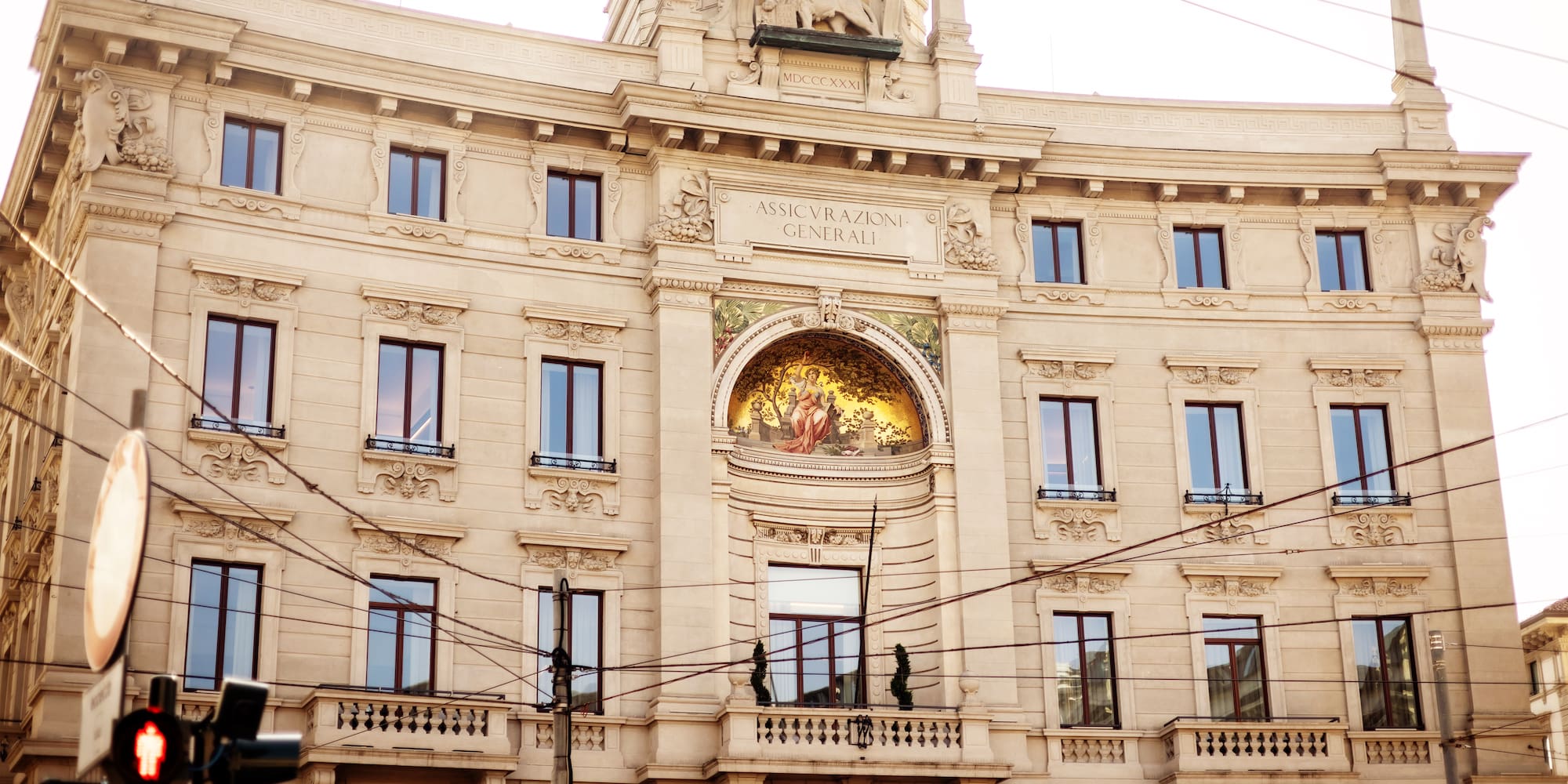 a building with a balcony and a statue on the side