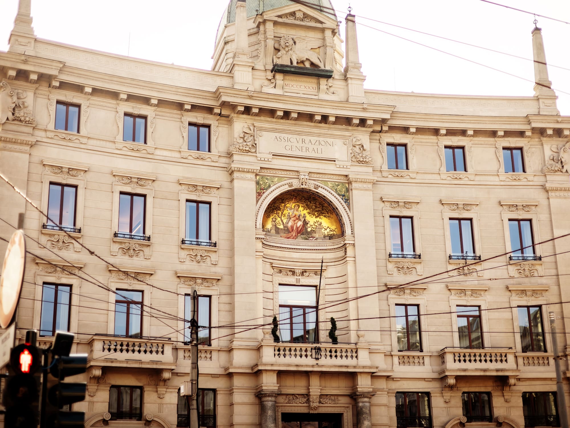 a building with a balcony and a statue on the side