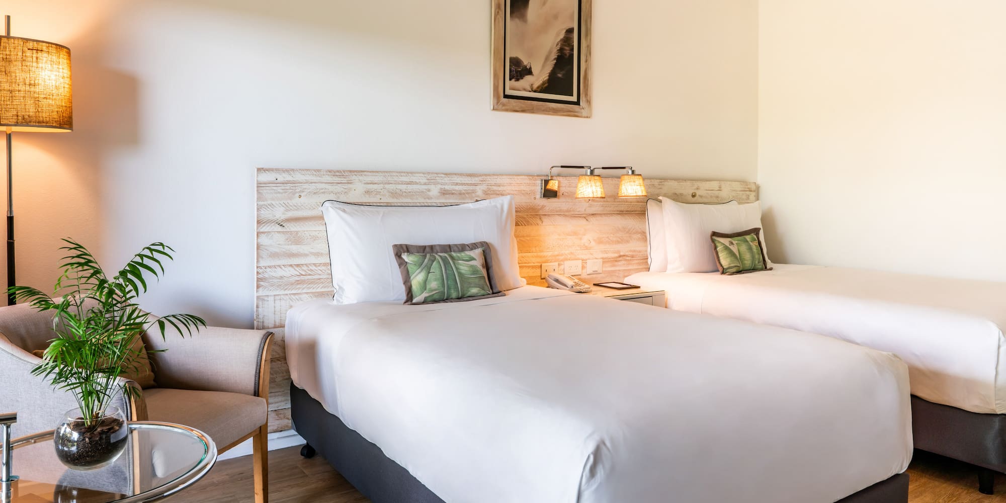 a room with two beds and a chair