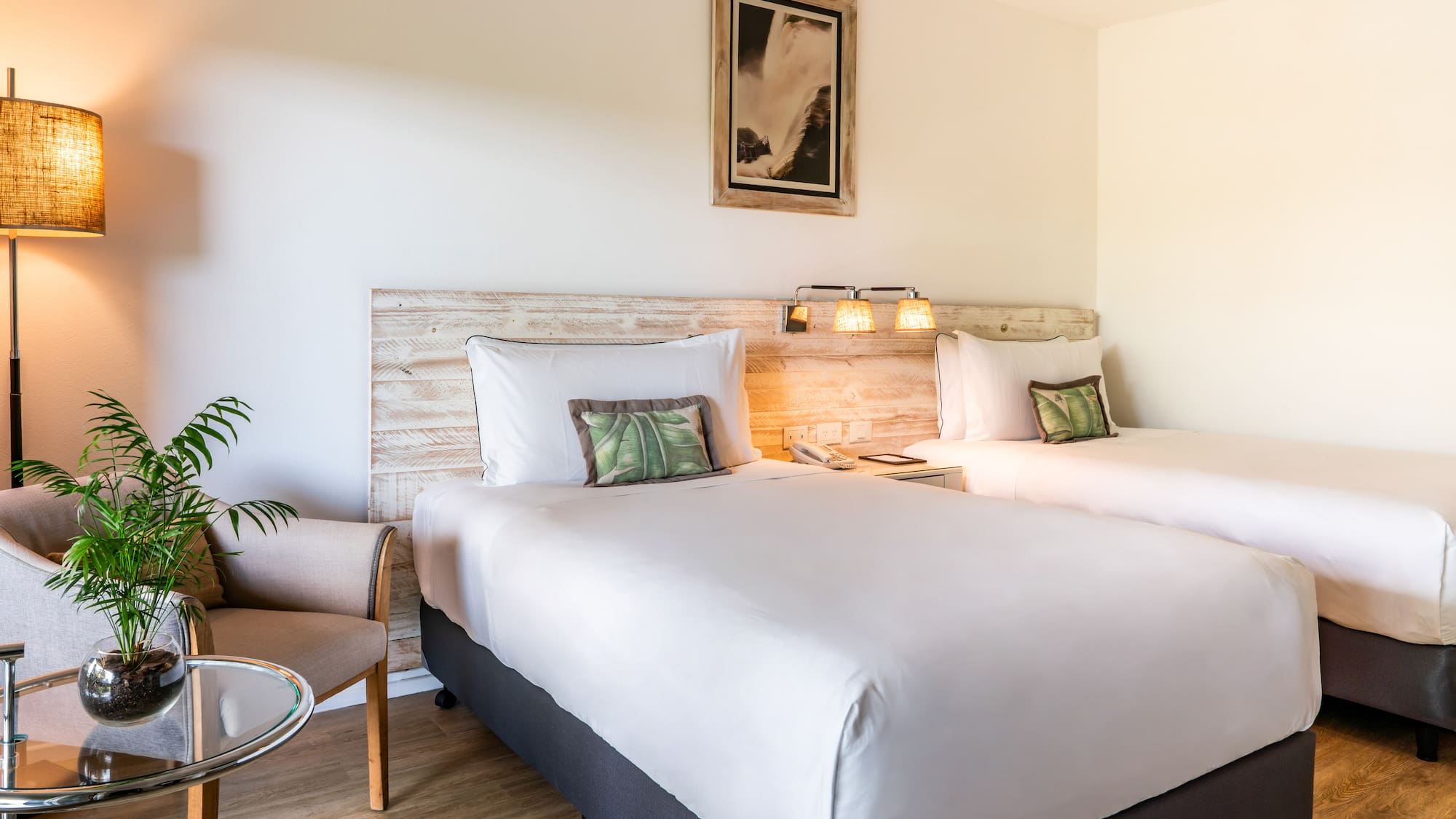 a room with two beds and a chair