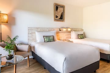 a room with two beds and a chair