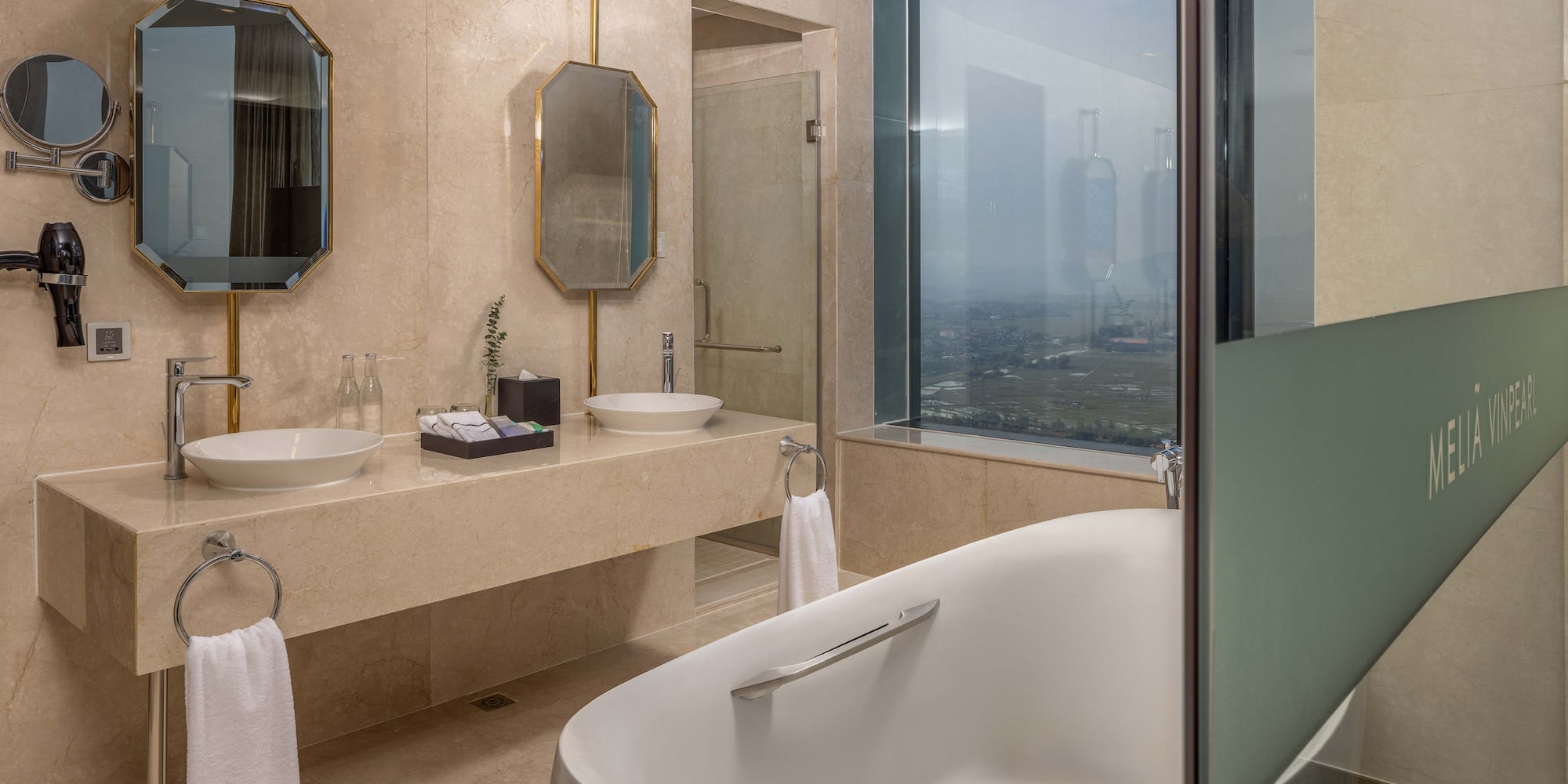 a bathroom with a tub and sinks