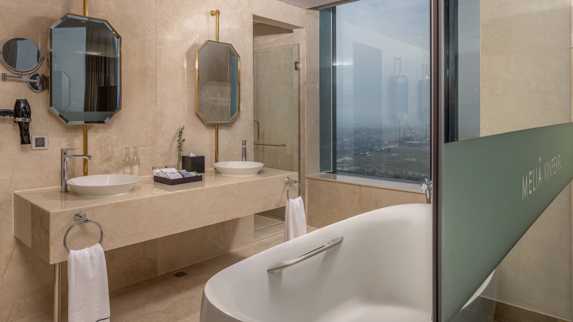 a bathroom with a tub and sinks